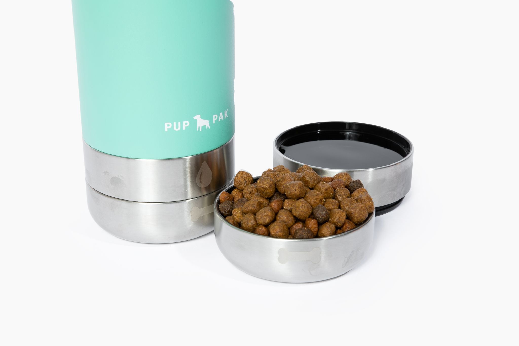 Close-up of the Aqua Pup Pak dog water bottle with its detachable stainless steel bowls, one filled with water and the other with kibble. The bottle's design allows pet owners to easily provide food and hydration for their pets during travel and outdoor activities. The durable and portable Pup Pak ensures pets stay nourished and hydrated on the go, making it an essential accessory for active pet owners.